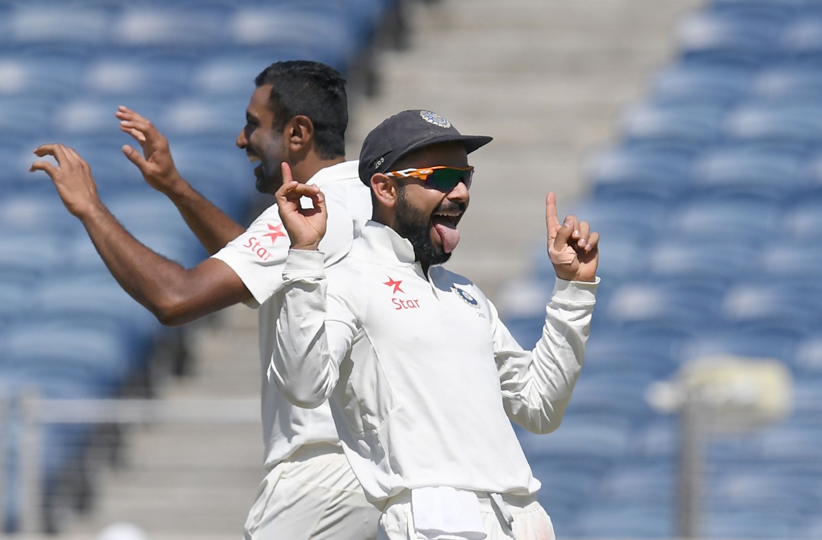 This file photo taken on February 23, 2017 shows India's captain Virat Kohli (R) and teammate Ravichandran Ashwin celebrate after the dismissal of Australia's captain Steve Smith during the first day of the first cricket Test match between India and Austr