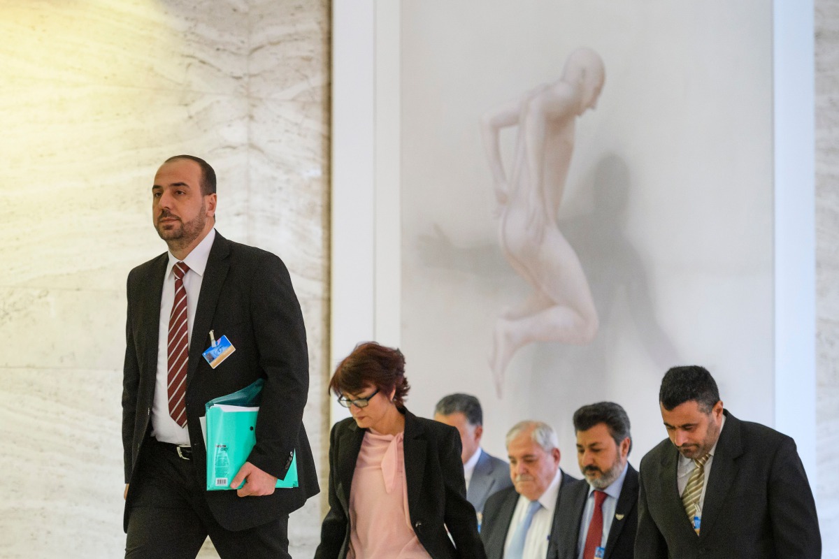 Syria's main opposition High Negotiations Committee (HNC) leader Nasr al-Hariri (L) arrives with his delegation for a press conference following a meeting with the United Nations Special Envoy for Syria during Syria peace talks in Geneva on March 31, 2017