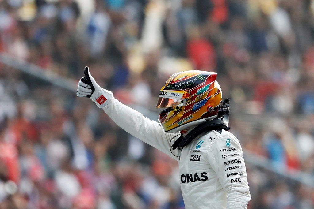 Mercedes driver Lewis Hamilton of Britain reacts after setting pole position in qualifying at the Shanghai International Circuit. REUTERS/Aly Song
