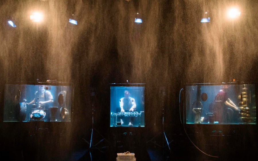 Members of the Between Music band perform with custom-made instruments in glass water tanks (AFP Photo/Jonathan Nackstrand)