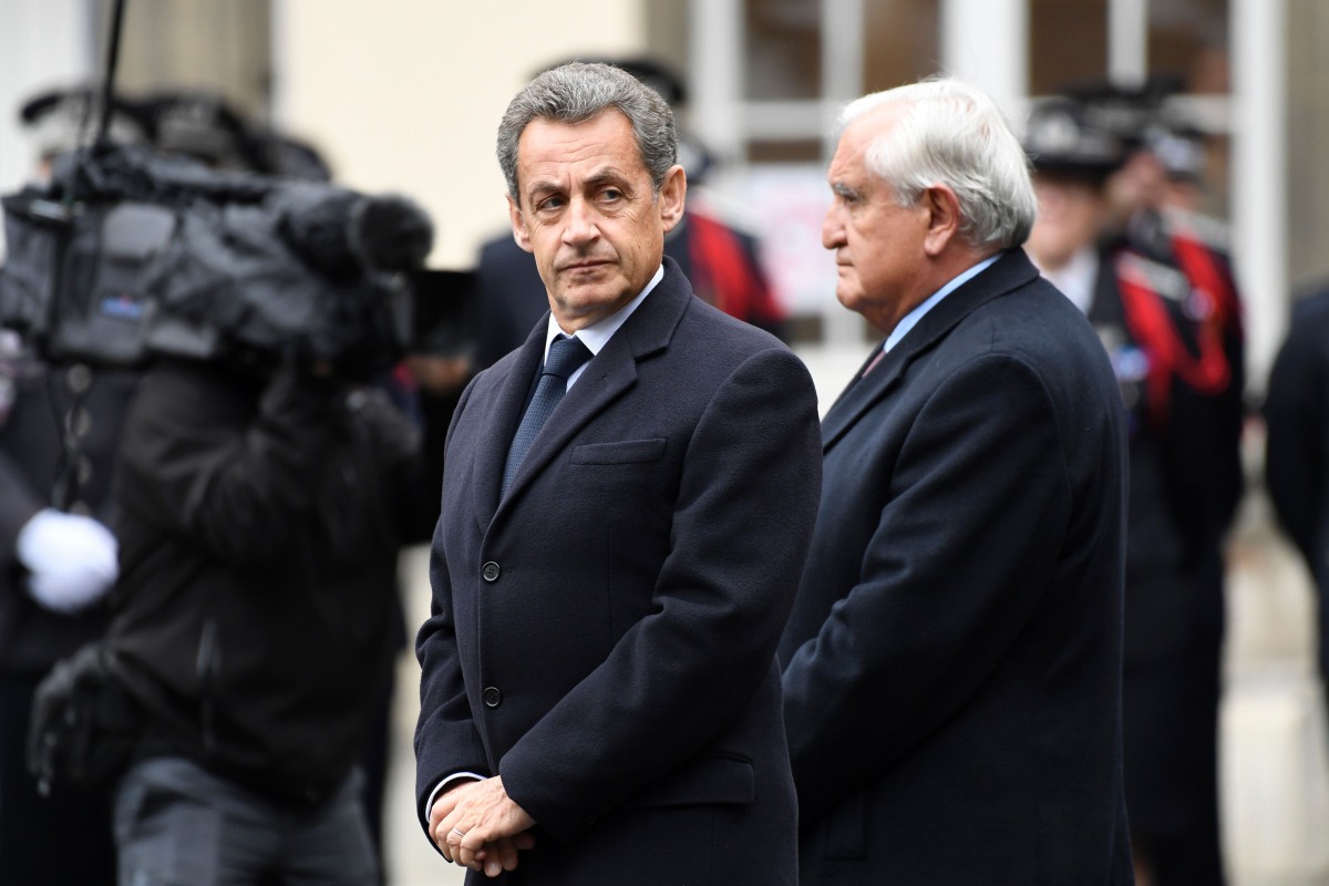 Former French President Nicolas Sarkozy (L) and former French Prime Minister, Jean-Pierre Raffarin attend a ceremony honouring the policeman killed by a jihadist in an attack on the Champs Elysees, on April 25, 2017 at the Paris prefecture building. AFP /