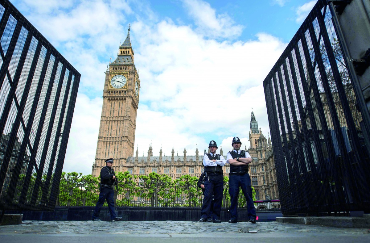 Armed police officers stand guard outside the Houses of Parliament in London 