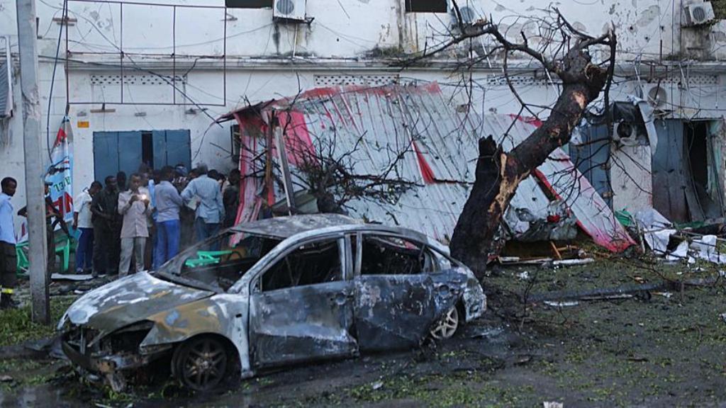 A damaged car and a broken shutter are seen, after a bomb-laden car parked near the Immigration and Citizenship Office exploded, at the explosion site in Mogadishu, Somalia on May 8, 2017. / AA.