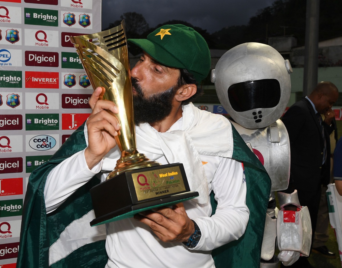 Retiring Pakistan cricket team captain Misbah-ul-Haq kisses the series trophy after winning the final test match and the series 2-1 against the West Indies at the Windsor Park Stadium in Roseau, Dominica on May 14, 2017. (AFP / MARK RALSTON)