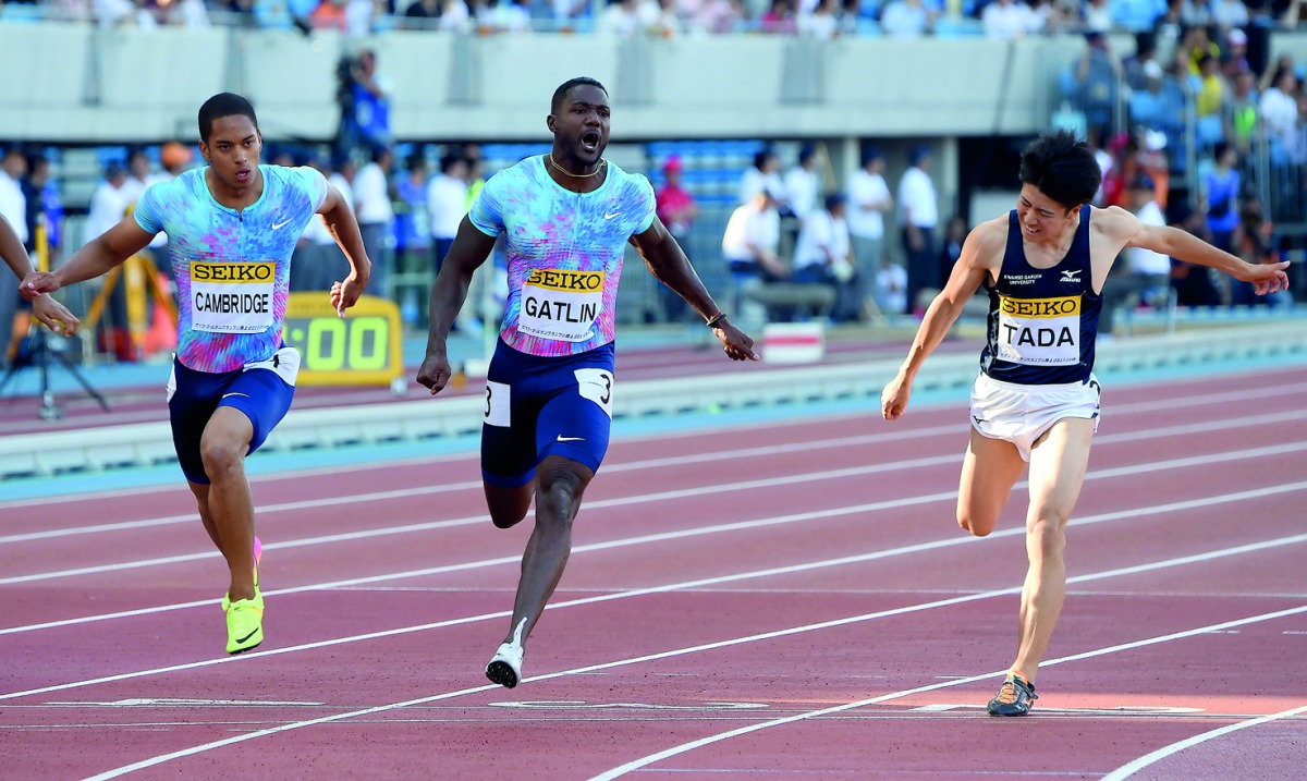 Justin Gatlin of the US leads Japanese runners Aska Cambridge (left) during their men's 100m event during the Golden Grand Prix track and field meet in Kawasaki, a suburb of Tokyo 