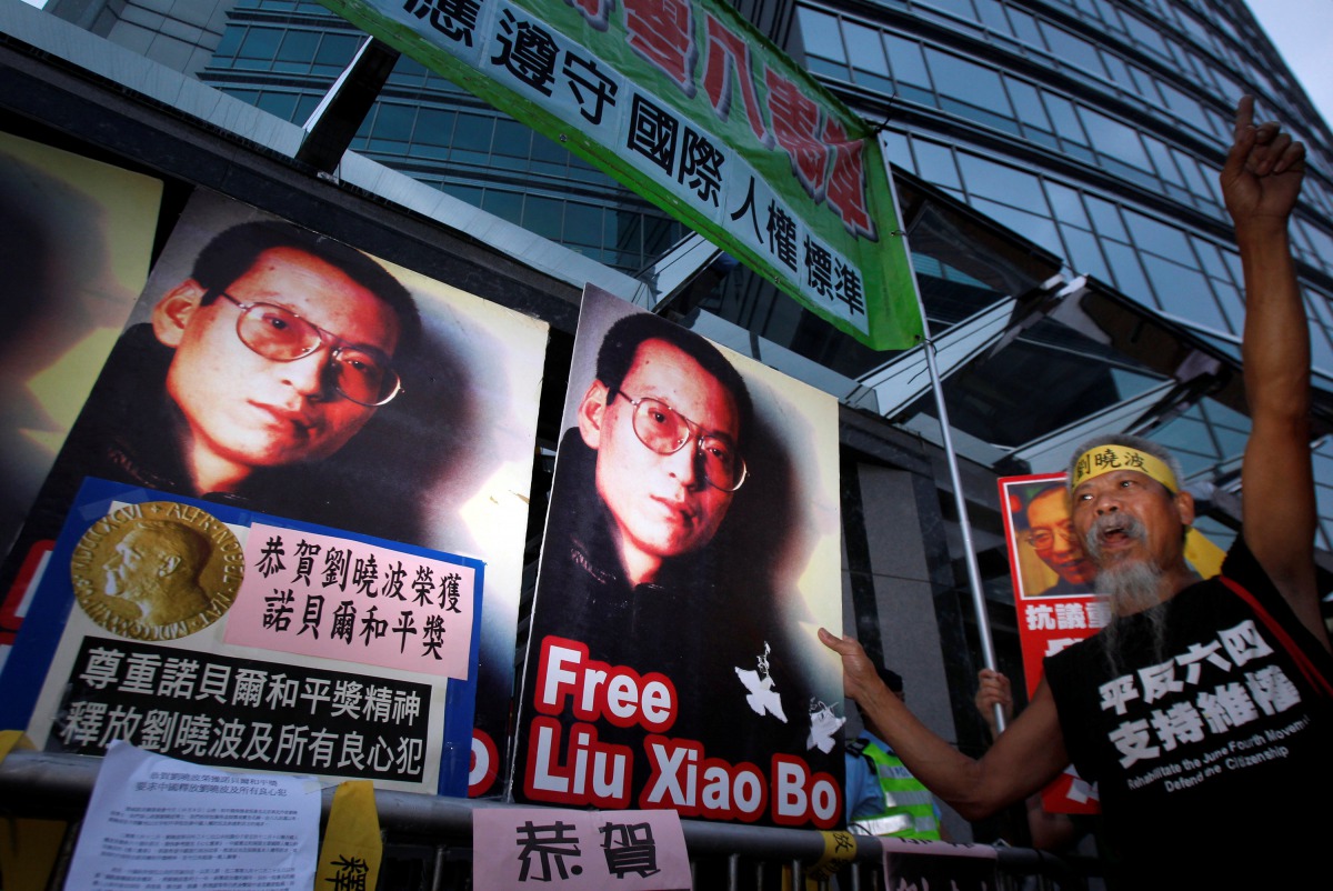 Protesters demonstrate outside the Chinese Foreign Ministry in Hong Kong October 8, 2010 demanding the release of jailed Chinese pro-democracy activist Liu Xiaobo.Chinese characters on the placard reads 