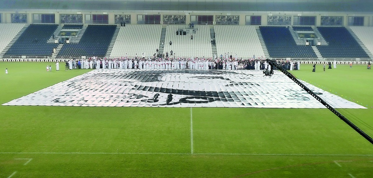 Citizens and residents taking part in creating ‘Tamim Al Majd’ image at Al Sadd stadium yesterday.  Pic: Baher Amin / The Peninsula