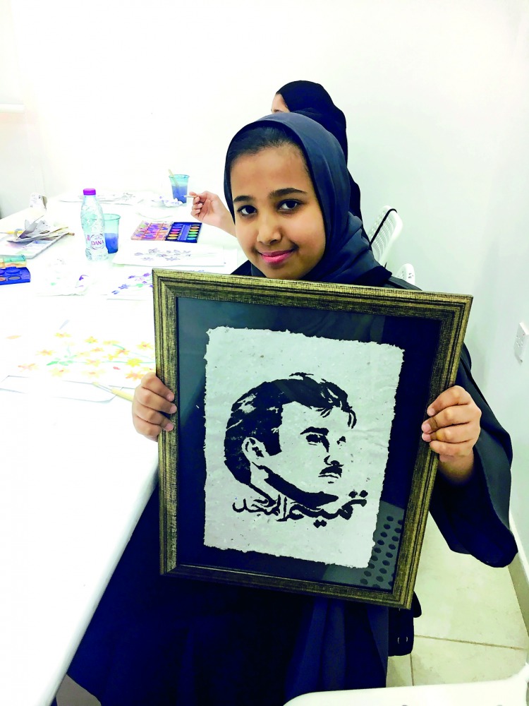 A girl with a ‘Tamim Al Majd’ image during the summer festival special ‘Tamim Al Majd Week’ at Girls Creativity Center, yesterday.   Pic: Amna Pervaiz Rao / The Peninsula
