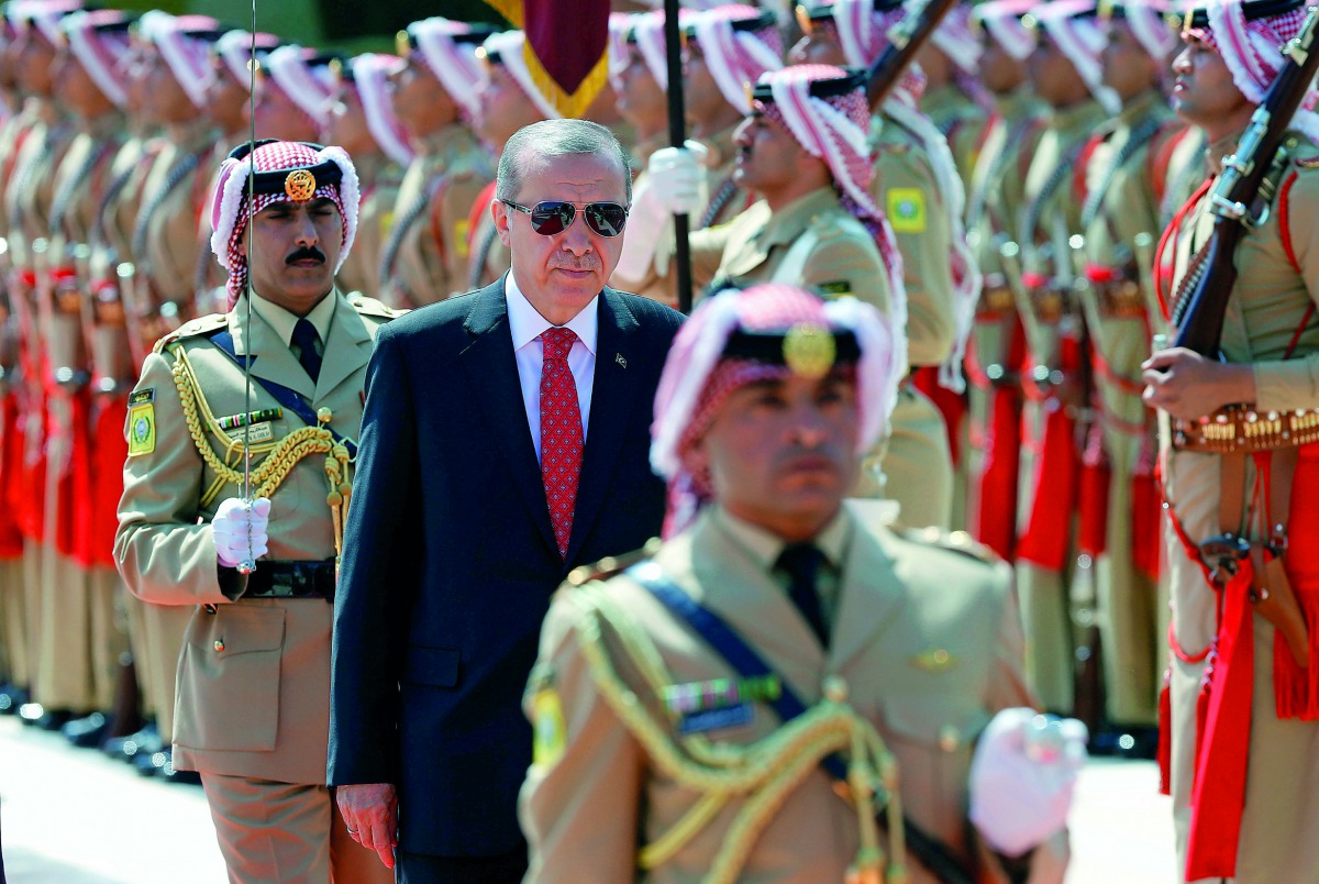 Turkish President Recep Tayyip Erdogan reviews the guard of honour at the Royal Palace in Amman, Jordan, yesterday.