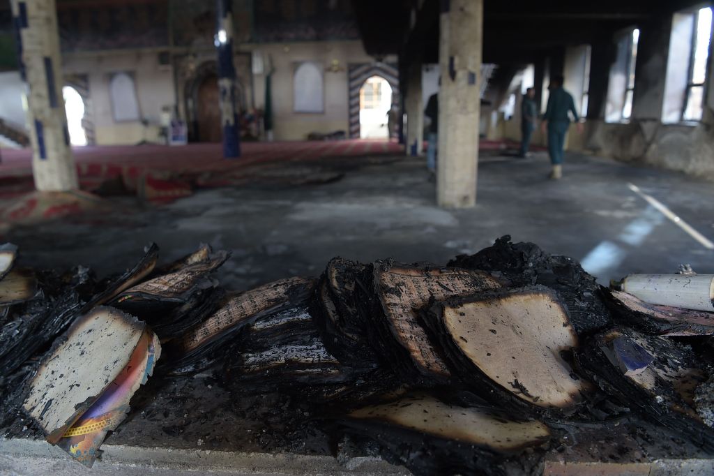 Burnt copies of the Koran are seen a day after a suicide attack on a Shiite mosque in Kabul on August 26, 2017.   AFP / SHAH MARAI
