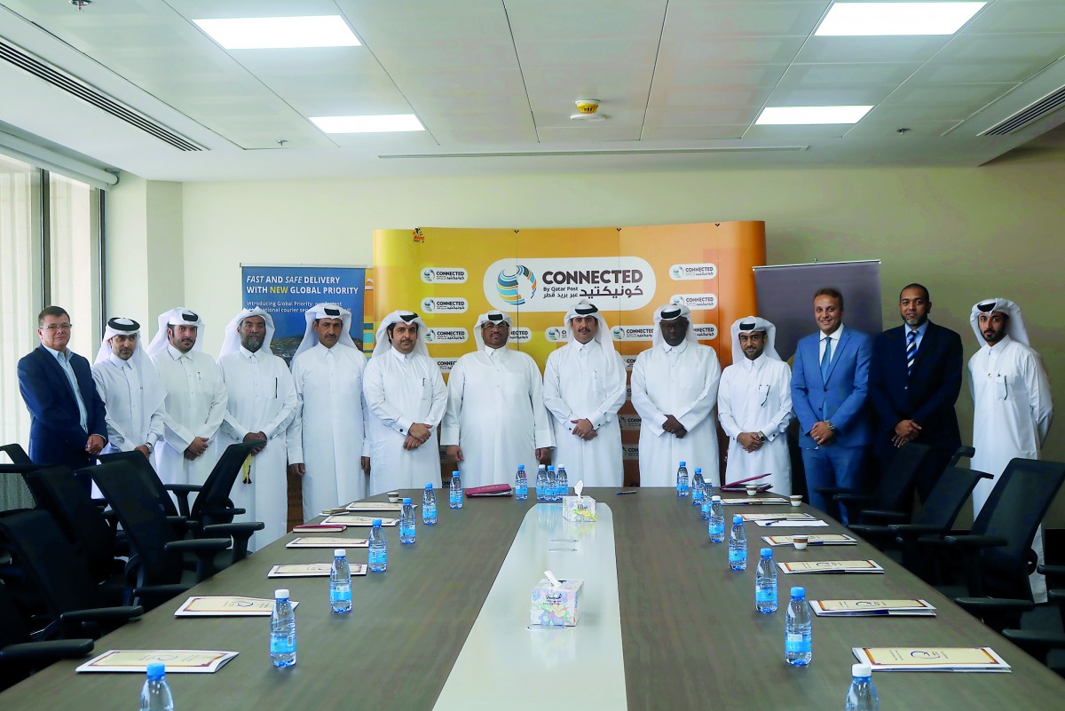 Officials of Qatar Post and the Civil Aviation Authority at the MoU signing ceremony at the Qatar Post Main Building.