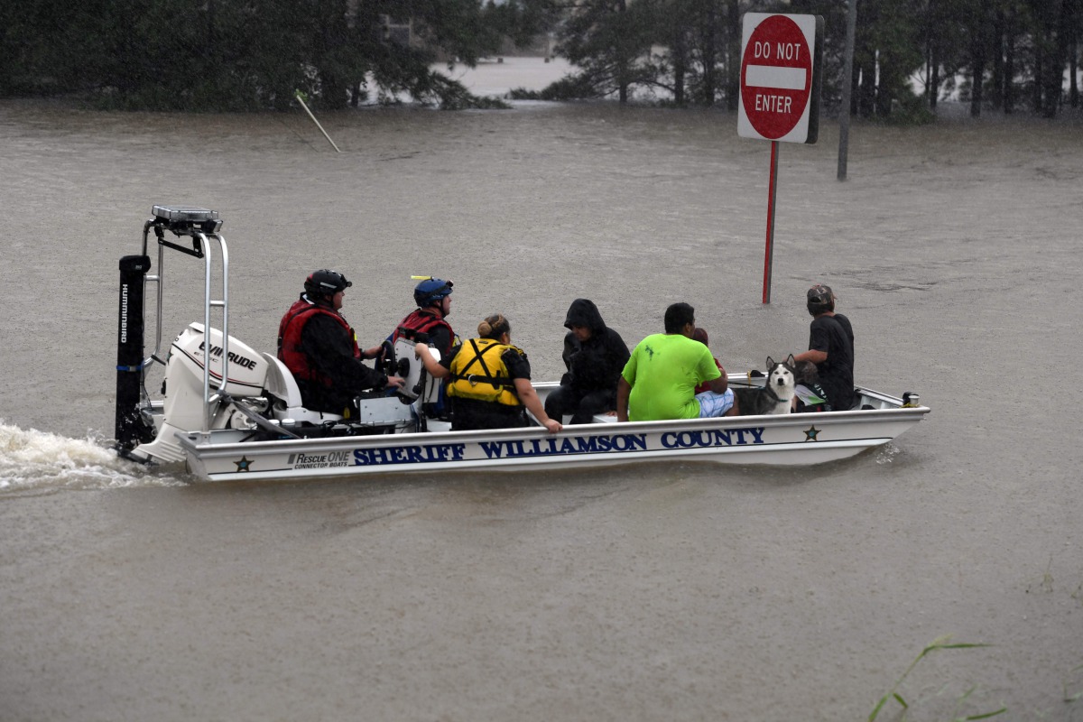 A Sheriff Dept boat rescues people after Hurricane Harvey caused heavy flooding in Houston, Texas on August 28, 2017. Rescue teams in boats, trucks and helicopters scrambled Monday to reach hundreds of Texans marooned on flooded streets in and around the 