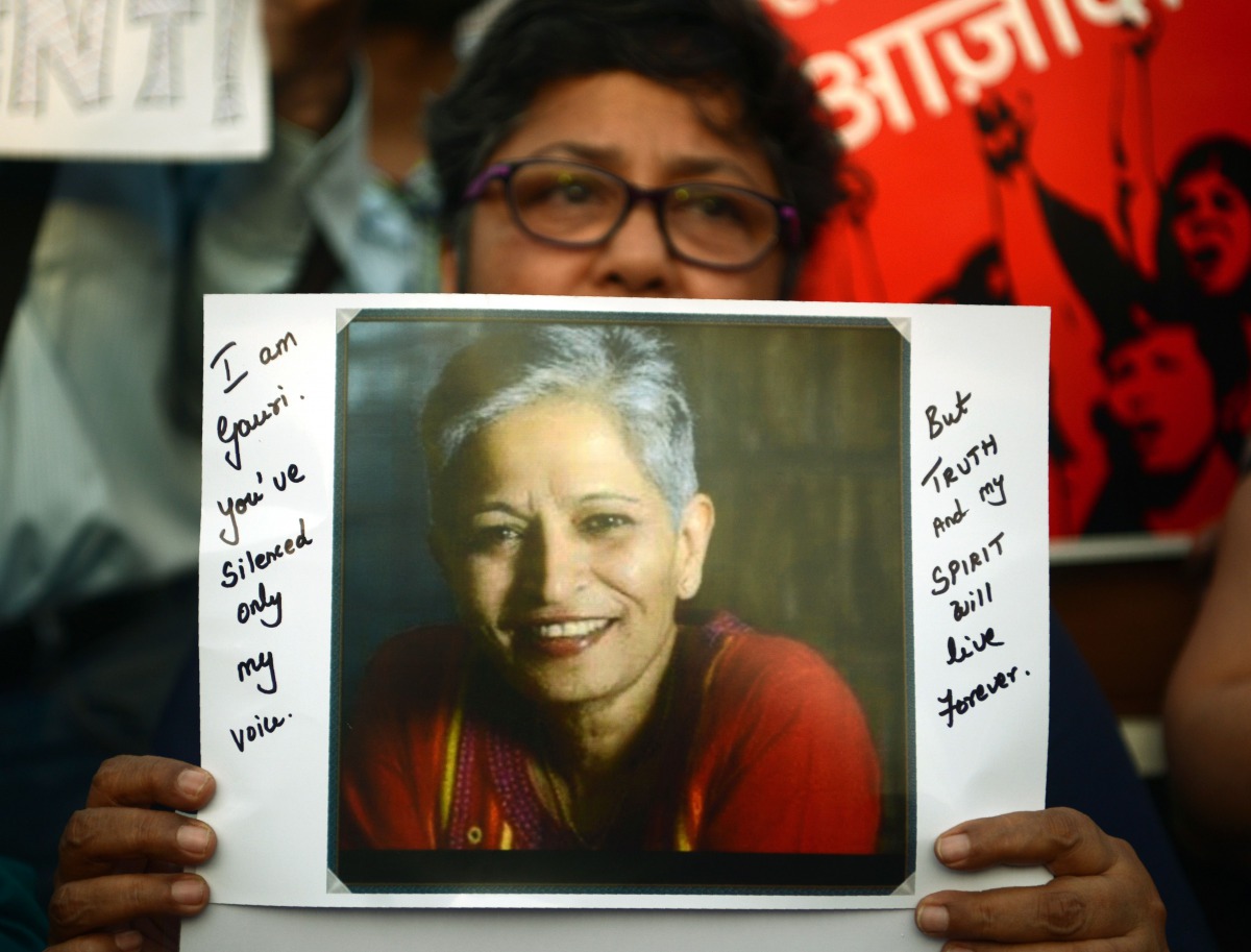 An protester holds a placard in a rally condemning the killing of journalist Gauri Lankesh, in Mumbai on September 6, 2017. AFP / Punit Paranjpe