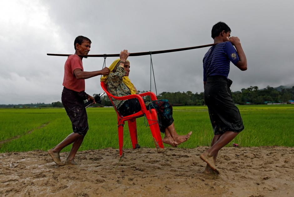 An old Rohingya Muslim being carried to safety.