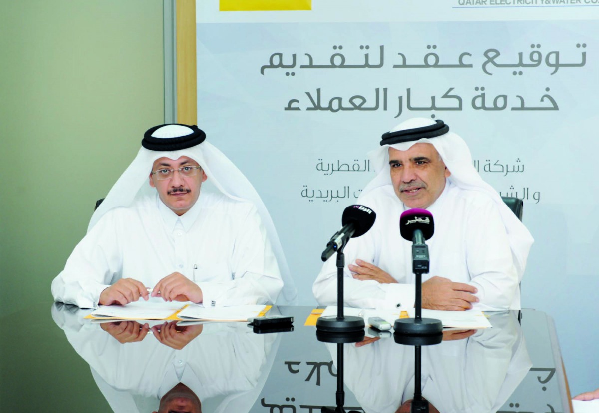 QEWC General Manager and Managing Director Fahad Hamad Al Mohannadi (right) with Q-Post Chairman and Managing Director Faleh Mohammed Al Nuaimi at the event yesterday.