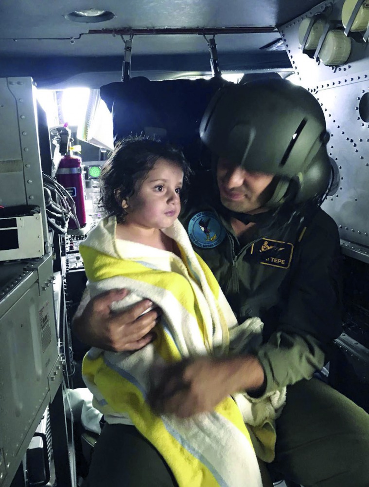 A wounded migrant girl is being taken to hospital after a fishing vessel carrying illegal migrants sank in the Black Sea off Turkey’s northwestern province of Kocaeli, yesterday.
