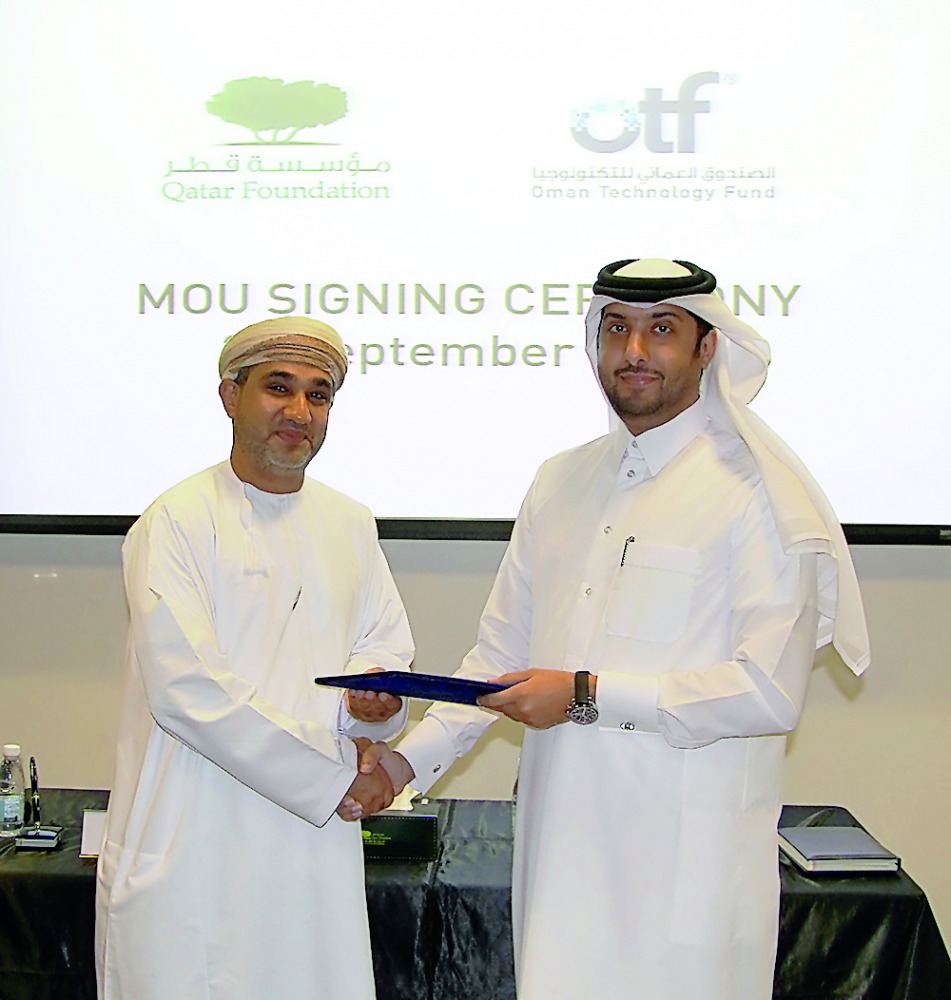 Officials of QF R&D and OTF during the signing ceremony. 
