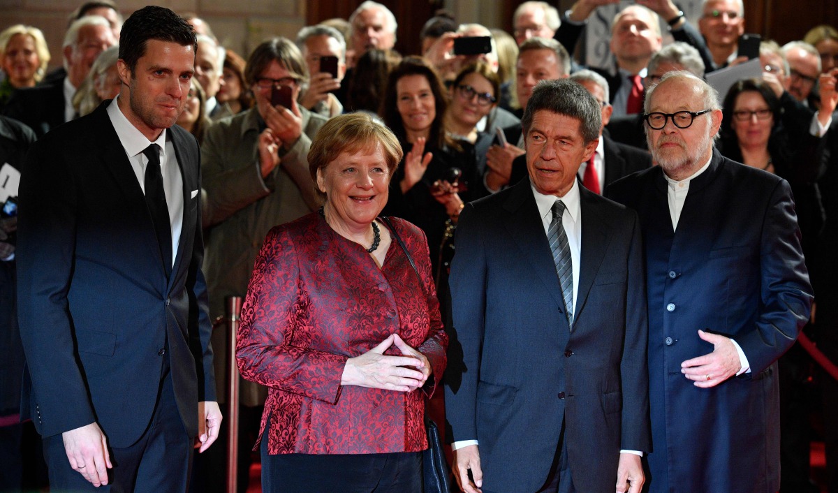 Intendants of the State Opera Juergen Flimm (R) and Matthias Schulz (L) pose with German Chancellor Angela Merkel (2L) and her husband Joachim Sauer ahead the re-opening of the State Opera in Berlin, on October 3, 2017.  AFP / John Macdougall
