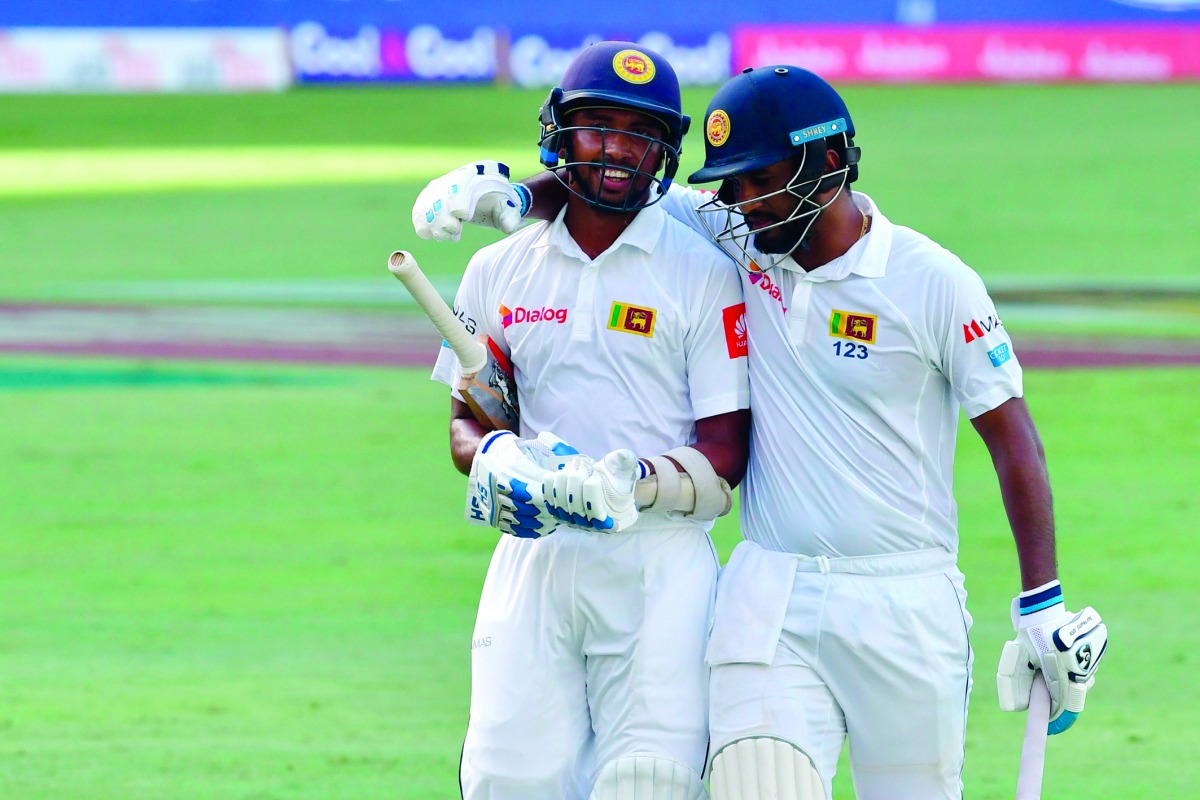 Sadeera Samarawickrama (left) and Dimuth Karunaratne of Sri Lanka leave the field during the first day of the second Test match against Pakistan at Dubai International Stadium in Dubai, yesterday.
