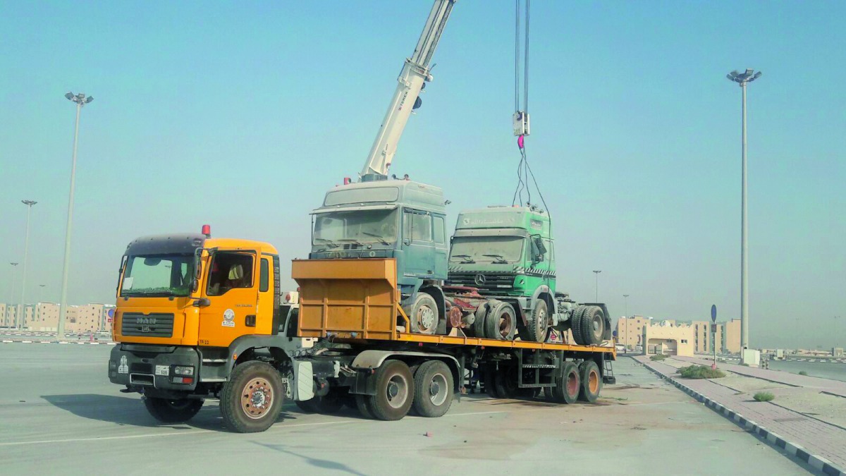 Abandoned trucks are being removed at Al Wakrah.