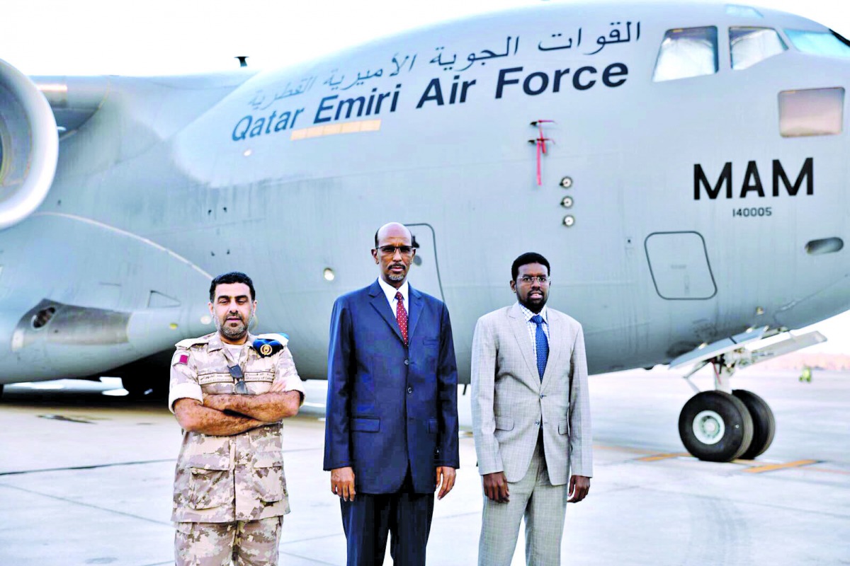 Qatar and Somalia officials standing in front of Emiri Air Force at the Mogadishu International Airport in Somalia, yesterday.