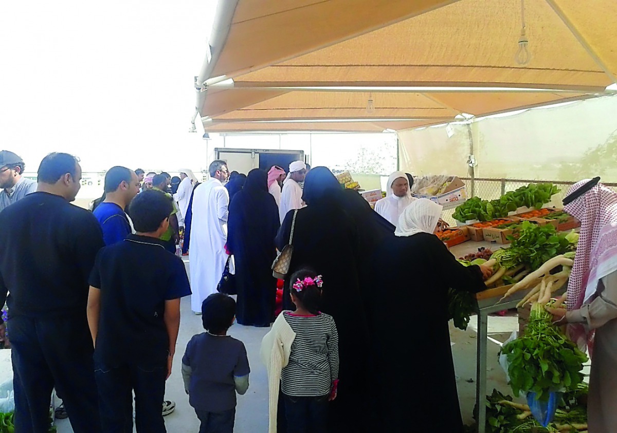 This file picture shows people buying vegetables at a winter market. 