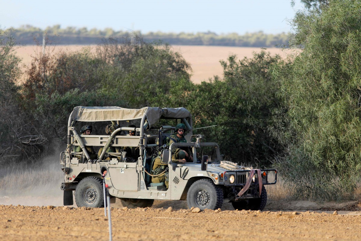 Israeli soldiers patrol close to the Israeli border with the Gaza Strip on October 30, 2017, near Kibbutz Kissufim in southern Israel. A Palestinian was killed and nine others injured when Israel blew up a tunnel stretching from the Gaza Strip into its te
