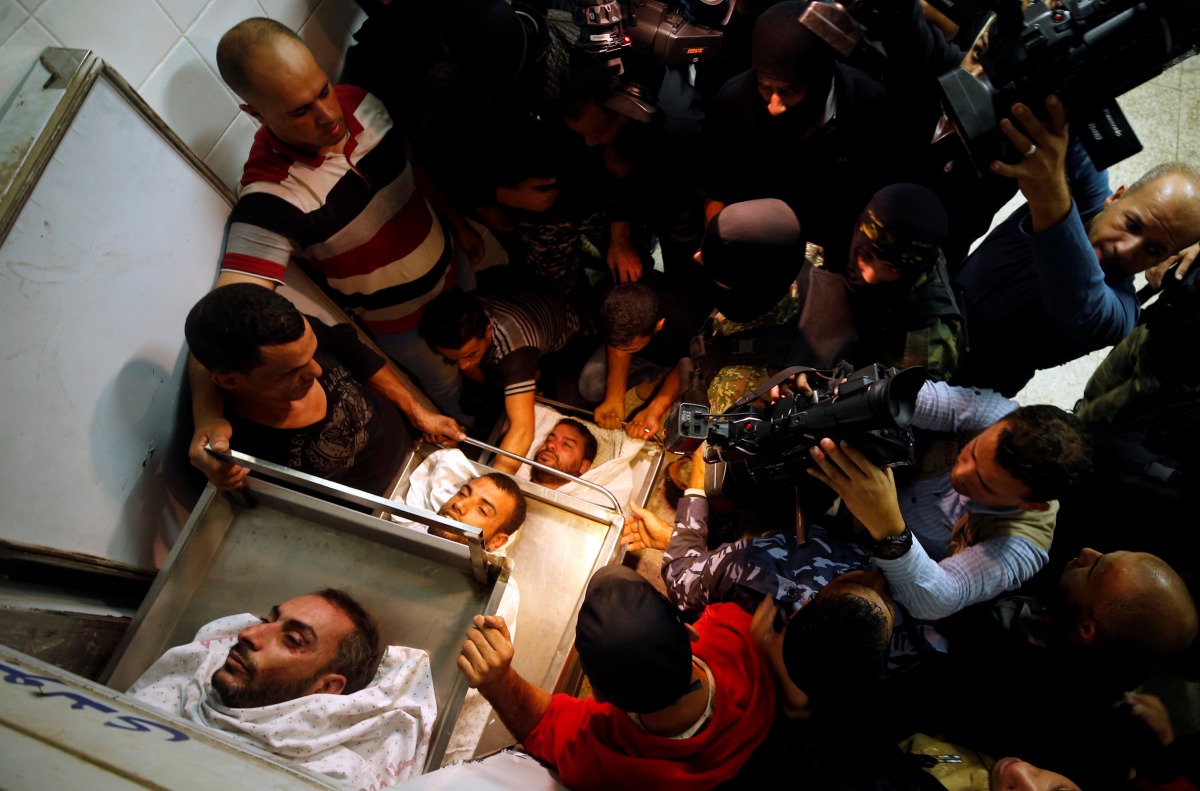 People gather around bodies of Palestinians killed in a tunnel near the border between Israel and central Gaza Strip October 30, 2017. Reuters/Mohammed Salem