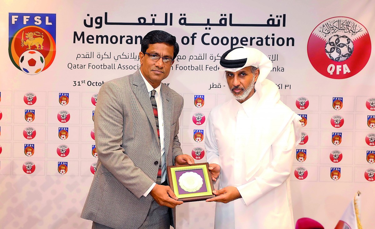 Sheikh Hamad bin Khalifa bin Ahmed Al Thani, President of the QFA hands a memento to  Anura De Silva, President of the Football Federation of Sri Lanka (FFSL) yesterday.