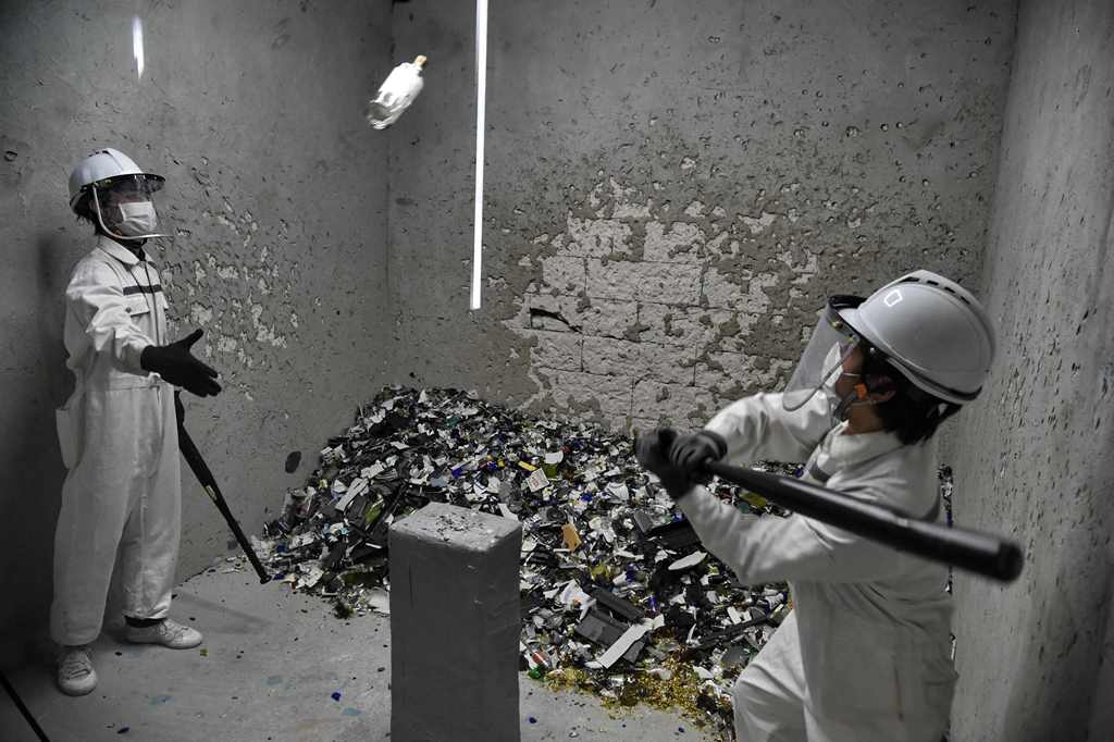 This photograph taken on October 19, 2017 shows Fragment Room employees smashing bottles during a demonstration in a 