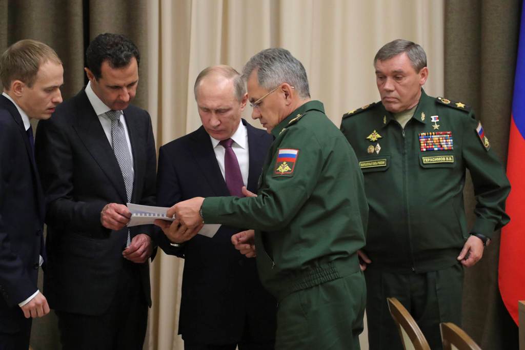 Russian President Vladimir Putin (C), Syrian President Bashar al-Assad (2nd L), Russian Defence Minister Sergei Shoigu (2nd R) and Chief of the General Staff of Russian Armed Forces Valery Gerasimov (R) attend a meeting in the Black Sea resort of Sochi, R