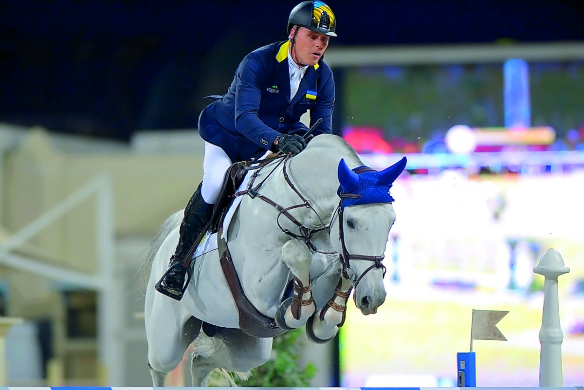 Ukrainian rider Rene Tebbel guides Cosun over an obstacle during the 160cm class of the QNB Al Rayyan International Show Jumping Championship at QEF’s Outdoor Arena yesterday.  Pictures: Lotfi Garci