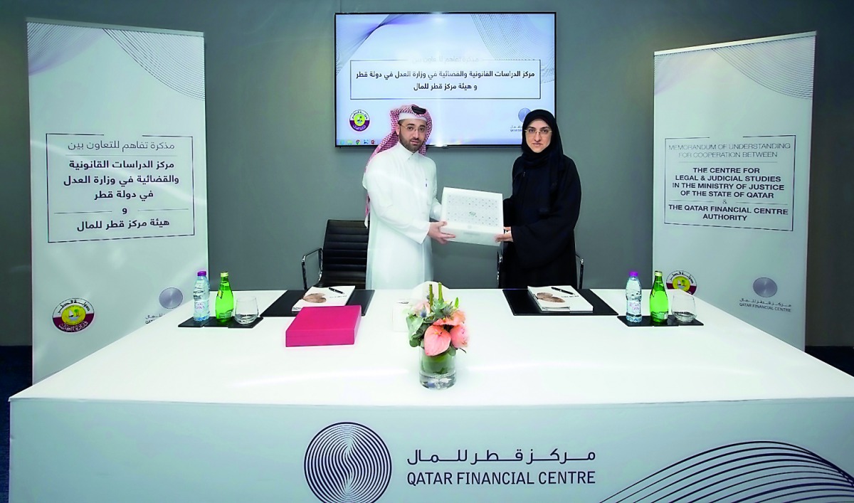 Nasser Al Taweel (left), Chief Legal Officer at the QFC Authority; and Fatma Abdulaziz Bilal, Director of the Legal and Judicial Studies Centre at the MOJ during the MoU signing