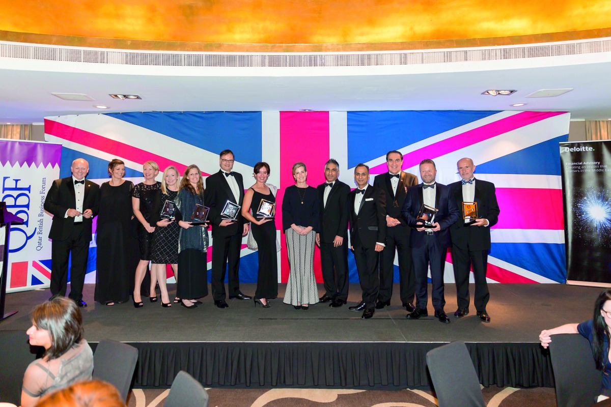 Ajay Sharma (fourth right), British Ambassador to Qatar, and other dignitaries and company officials, posing for a group photo with the winners of the 3rd QBBF annual awards at the event. 