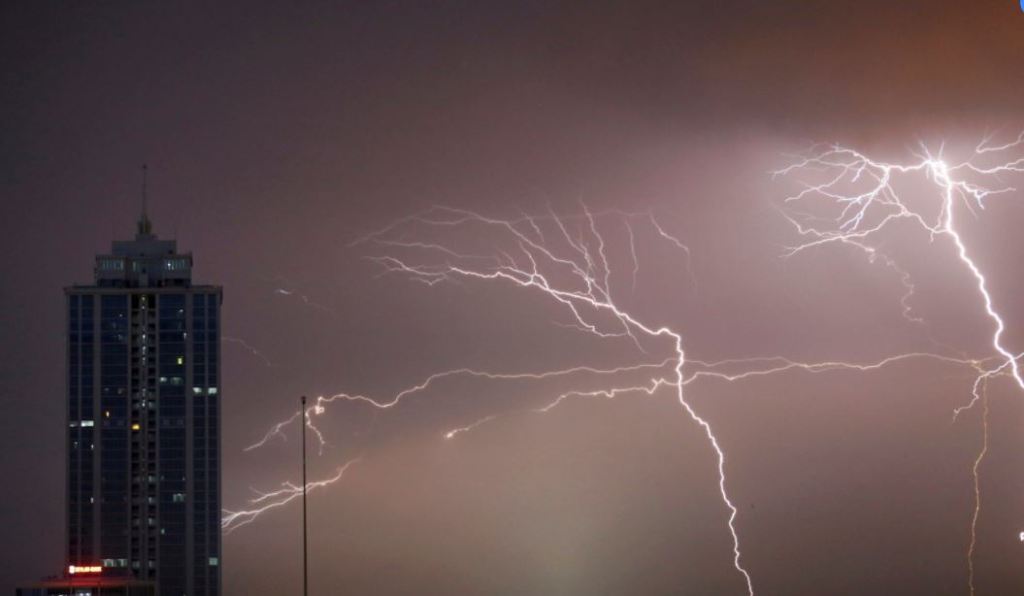 Lightning strikes behind commercial tower near a financial city in Colombo, Sri Lanka. / Image: REUTERS/Dinuka Liyanawatte.