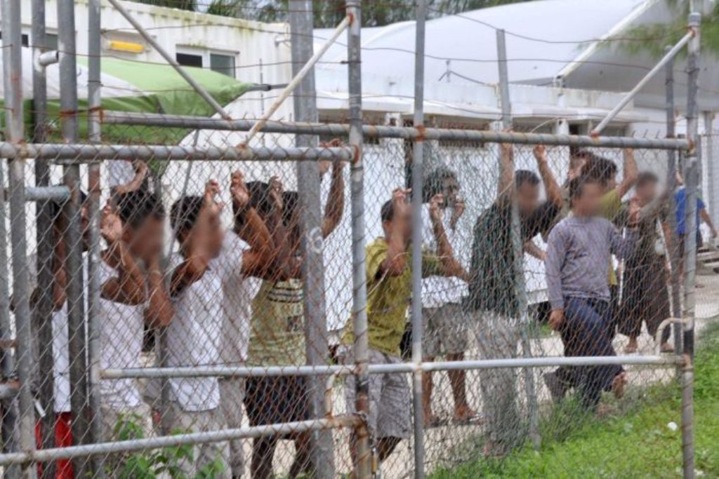 A file photo of Asylum-seekers looking through a fence at the Manus Island detention centre in Papua New Guinea. Reuters