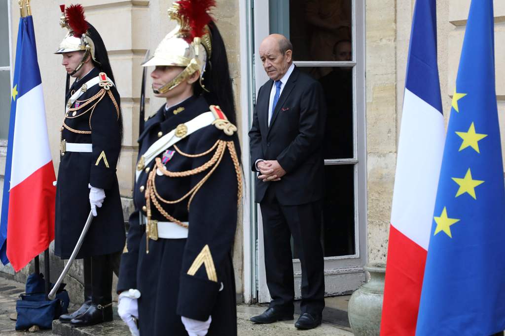 French foreign affairs minister Jean Yves Le Drian stands at the entrance of the castle of la Celle Saint cloud for a summit from the underfunded G5 Sahel anti-terror coalition on December 13, 2017. / AFP / ludovic MARIN.