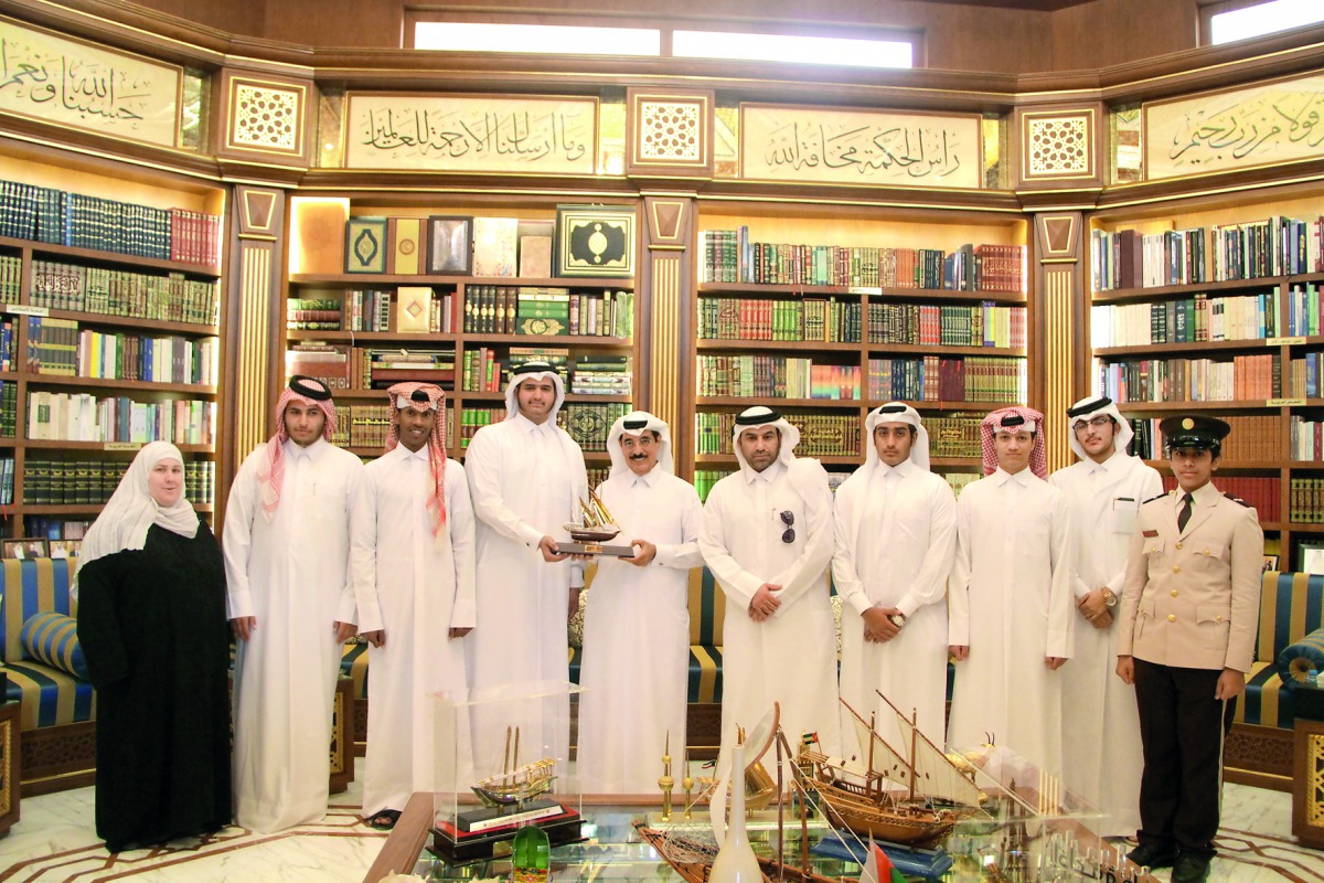 H E Dr Hamad bin Abdulaziz Al Kawari with cadets and teachers at his library.