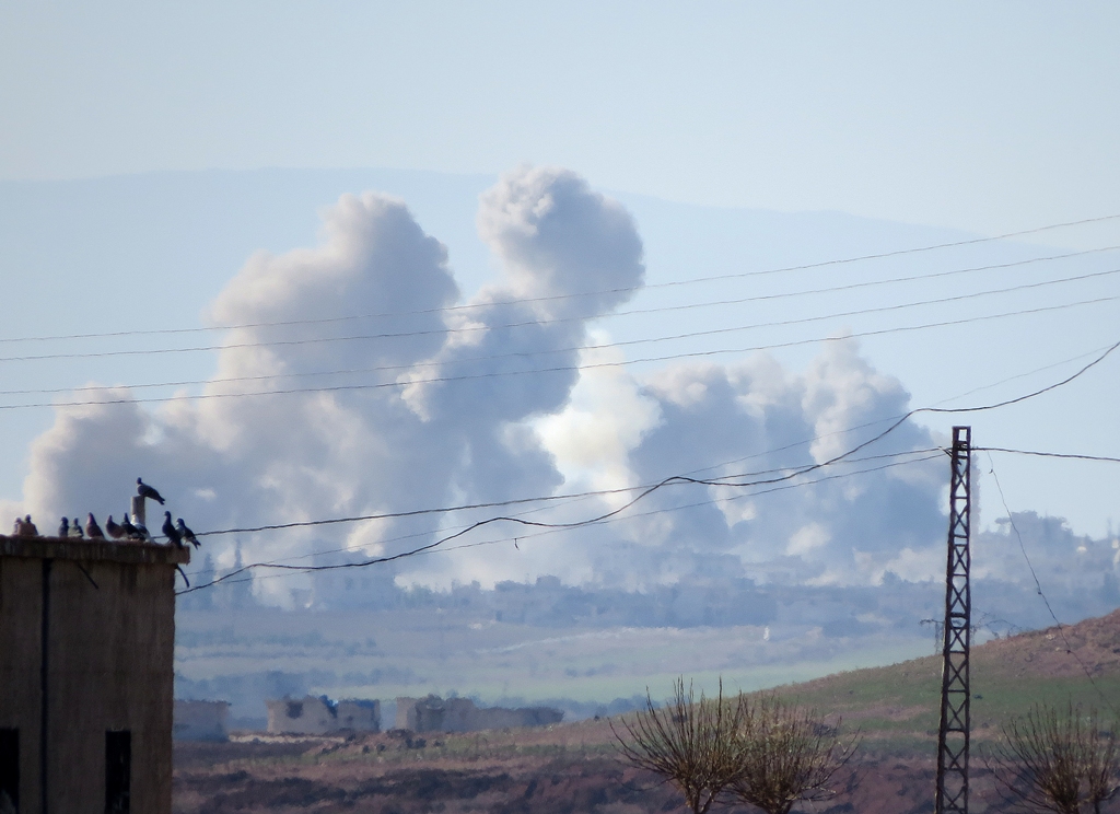 Smoke rises after Assad regime's warplane carried out airstrikes over Thamanyah district of Idlib in Syria on December 26, 2017. Ekrem Masry - Anadolu