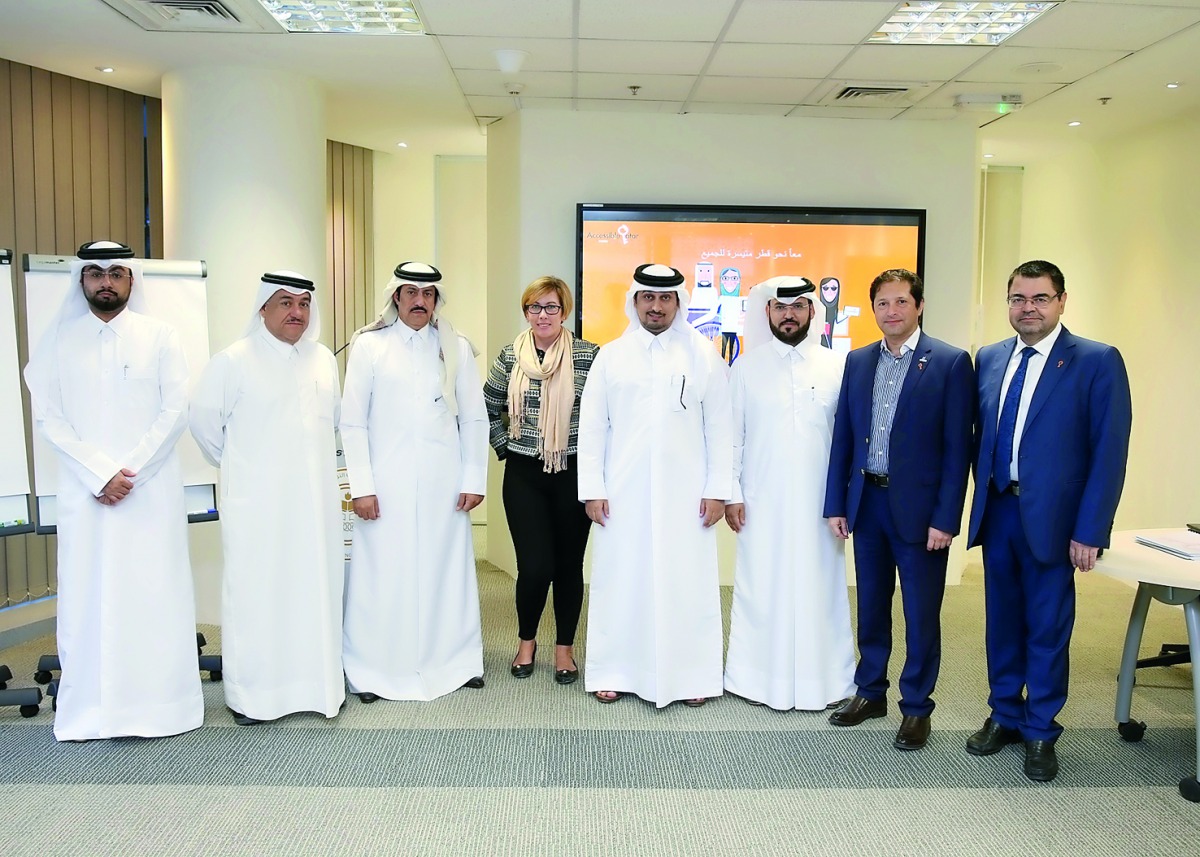 QNCECS Secretary-General, Dr. Hamda Hassan Al Sulaiti, and other officials at a workshop on the use of the electronic application for people with disabilities.