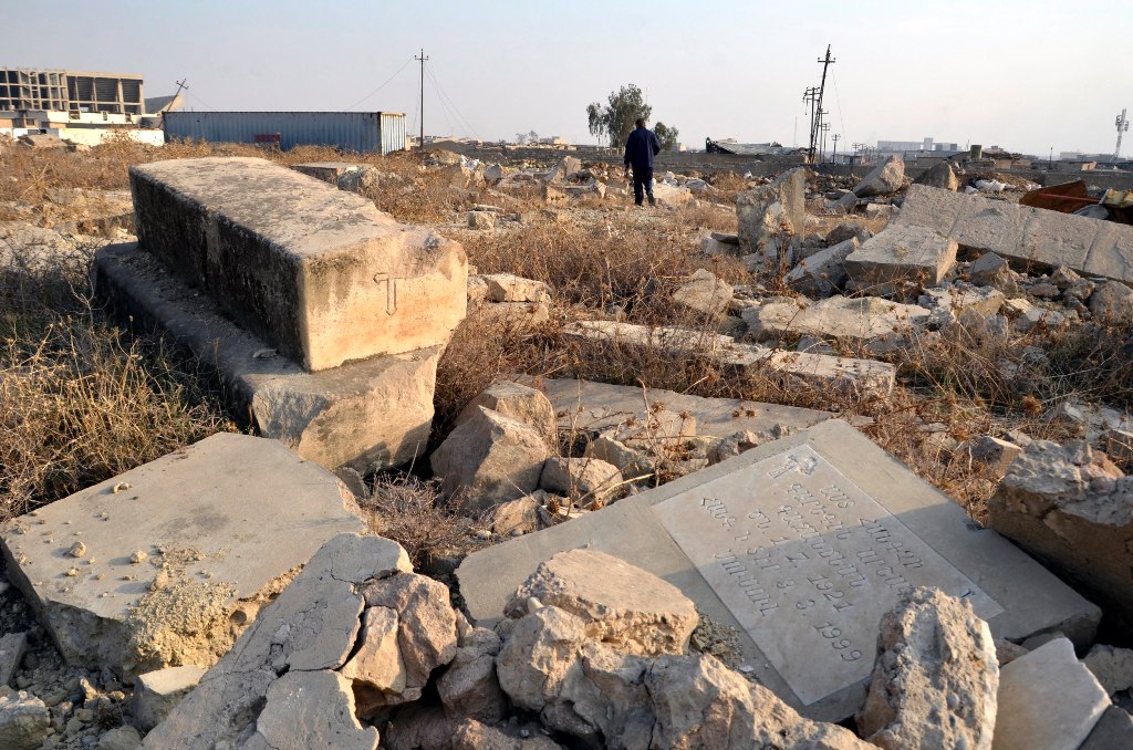 An Iraqi man walks amid the remains of headstones of British soldiers who were killed during the first and second world wars, at the Mosul War Cemetery in Mosul city, northern Iraq, 17 January 2018. EPA/AMAR SALIH
