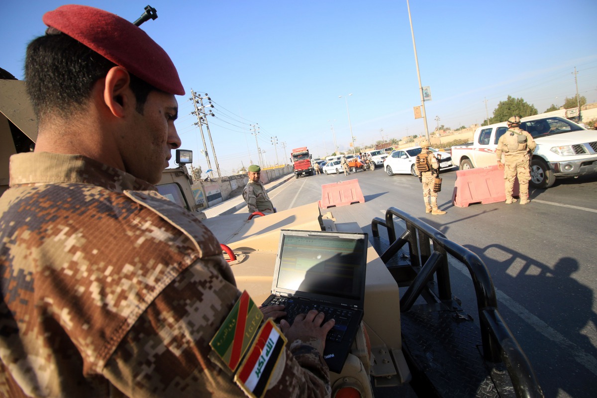 Iraqi soldiers control one of several checkpoints they set up along the main 50 kilometre road between the area of Karmat Ali on the northern outskirts of Basra and the town of Al Dayr.