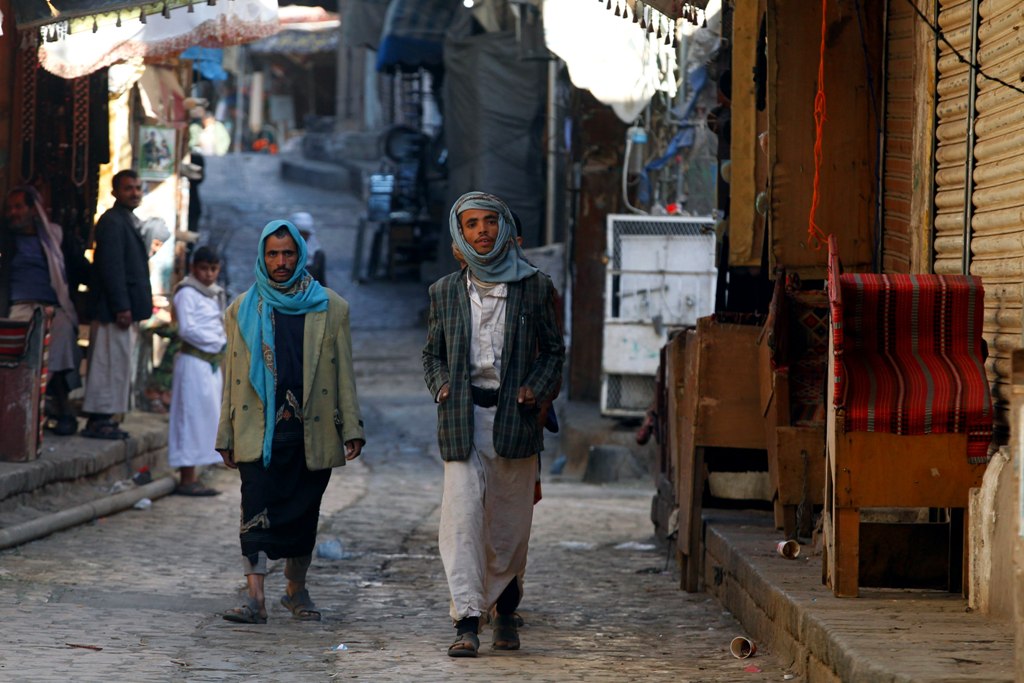 Yemenis walk through a market in the old city of Sana'a, Yemen, 19 January 2018. EPA/YAHYA ARHAB
