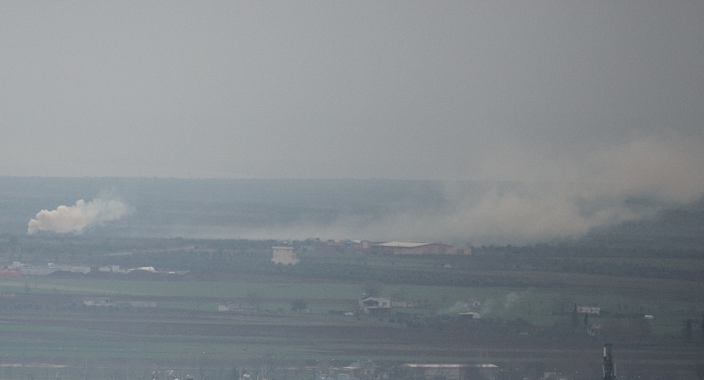 A photo taken from Turkey's Kilis shows smokes rising as Turkish army continues to hit PYD/PKK terror group targets within the 'Operation Olive Branch' launched in Syria's Afrin, on January 21, 2018 in Kilis, Turkey. Kerem Kocalar - Anadolu 
