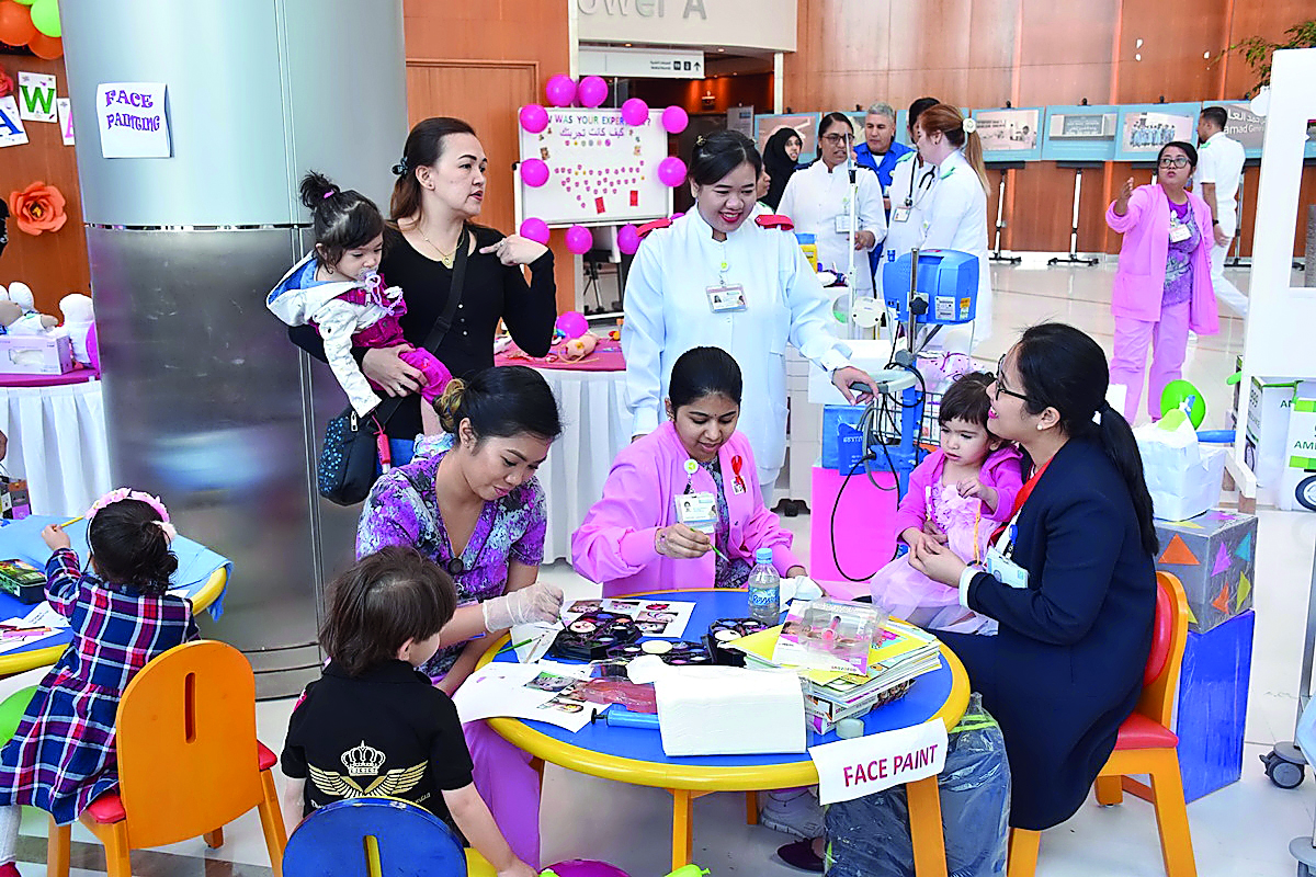 Parents with kids at Al Wakrah Hospital getting information from healthcare professionals about the new play therapy programme introduced by HMC. 