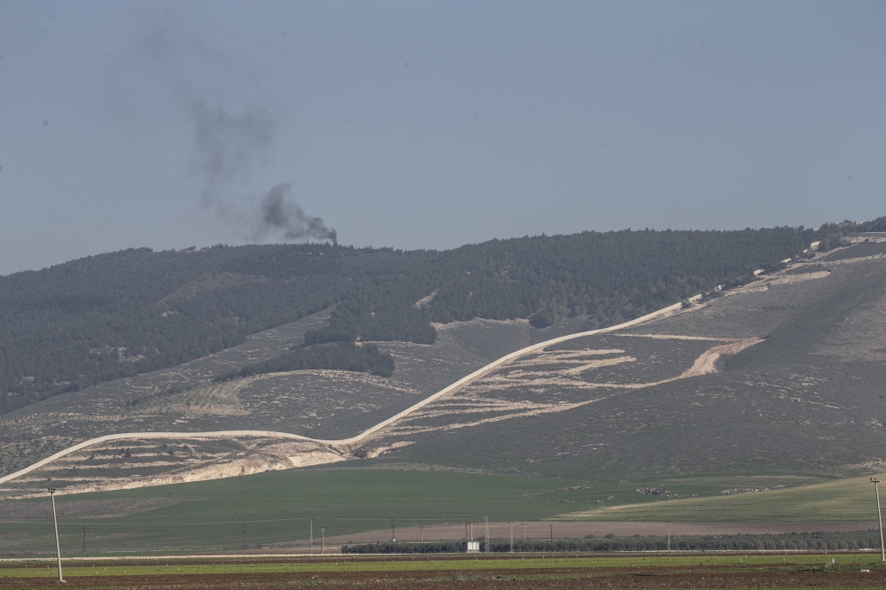 A photo taken from Turkey's Hatay province, on January 30, 2018 shows smoke rising as the PYD/PKK terror group targets on the opposite side of Reyhanli and Hassa districts being hit within the 'Operation Olive Branch' launched in Syria's Afrin.  Cem Genco