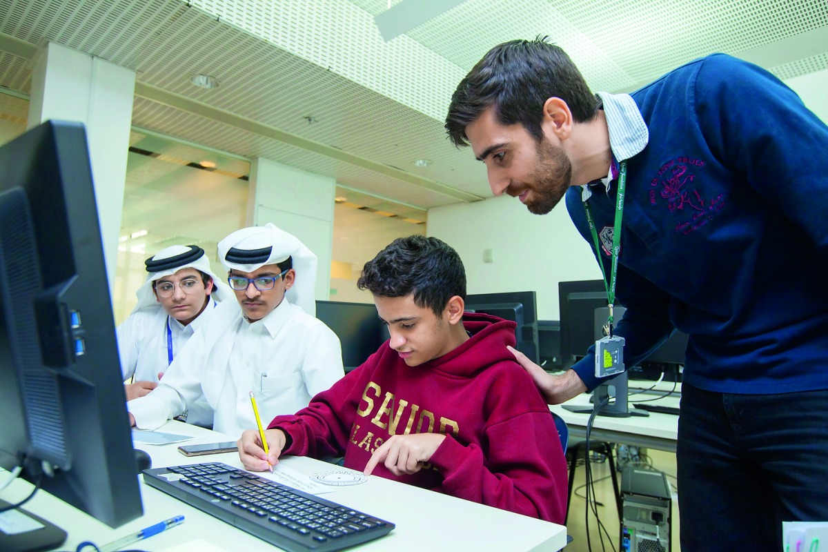 A teacher trains students during the computer engineering winter camp Innovate.Create organised by HBKU. 