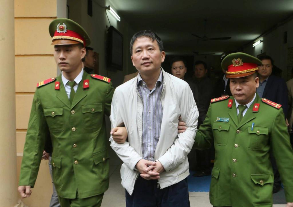 File photo of PVC's former chairman Trinh Xuan Thanh is escorted by police officers from a court to prison after verdict session in Hanoi, Vietnam January 22, 2018. VNA/Doan Tan via REUTERS