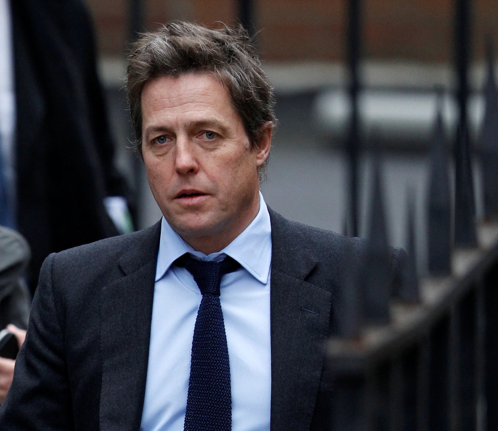 FILE PHOTO: British actor Hugh Grant arrives at the Leveson Inquiry at the High Court in central London, Britain November 21, 2011. REUTERS/Andrew Winning/File Photo