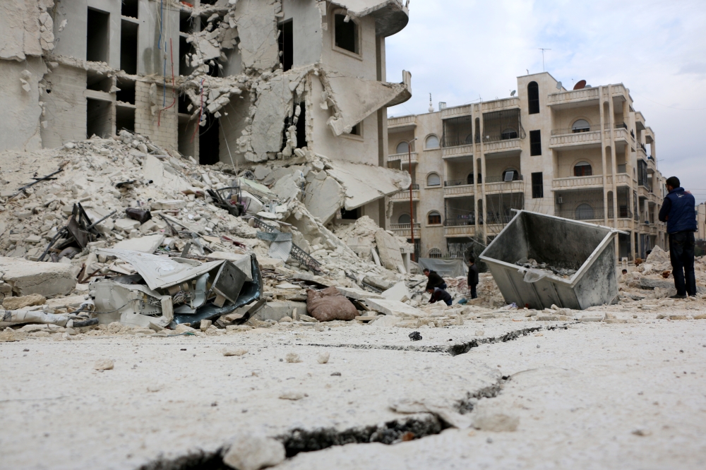 Members of civil defense carry out a search and rescue operation after an airstrike hits the city center of Idlib, Syria on February 5, 2018. Ahmet Rahhal - Anadolu